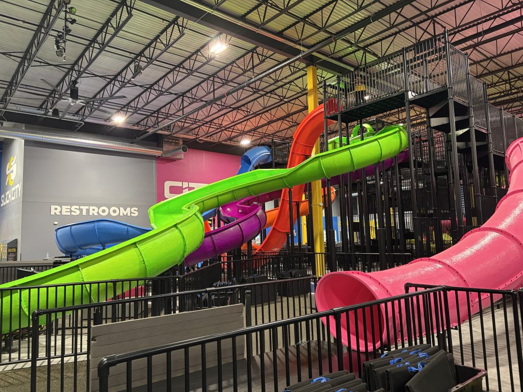 Inside Slick City Woodbury indoor action park with slides and arcade